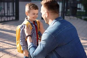 A parent helping a child prepare for the day